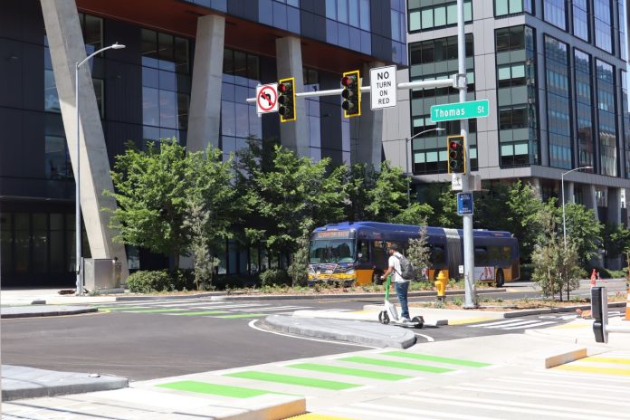 The view looking north on Dexter shows a Route 62 bus approaching the intersection.