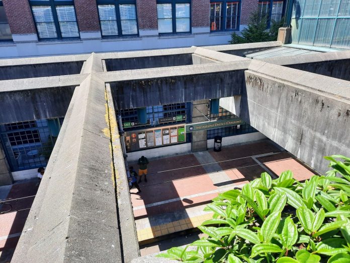 A view of the recessed Chinatown station platform from the surface, looking down through the concrete lattices overhead.