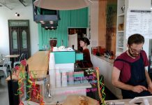 Op-Ed: Seattle Council Won’t Get Away with Gutting Minimum Wage Law Two servers behind the counter at a cafe, one at the register and another at the espresso machine.