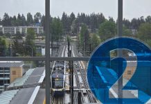 2 Line Beats Ridership Expectations, 1 Line Has Second-Best Month Ever A 2 icon decorates the mezzanine level overlooking the station platform with northern edge of downtown Bellevue in the background