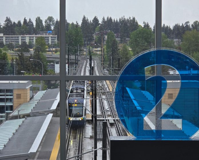 A 2 icon decorates the mezzanine level overlooking the station platform with northern edge of downtown Bellevue in the background