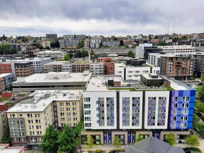 South Lake Union apartment blocks - Trumm 20240503 An rooftop view of rows of midrise apartments in South Lake Union with Capitol Hill in the distance.