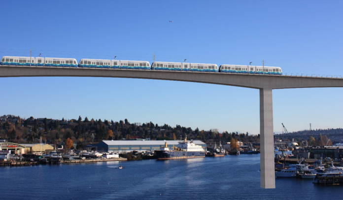 image A rendering shows a simple concrete bridge with a high span over Salmon Bay, with piers in the background.