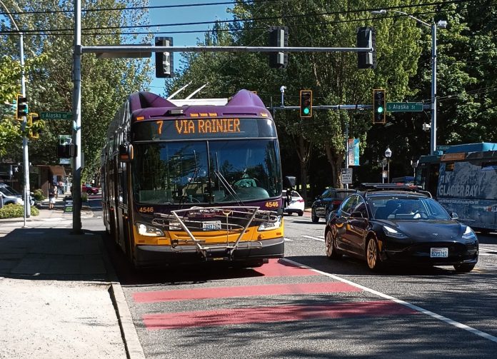 Route 7 bus lane A Route 7 bus comes down Rainier Avenue on a sunny day in a red bus lane
