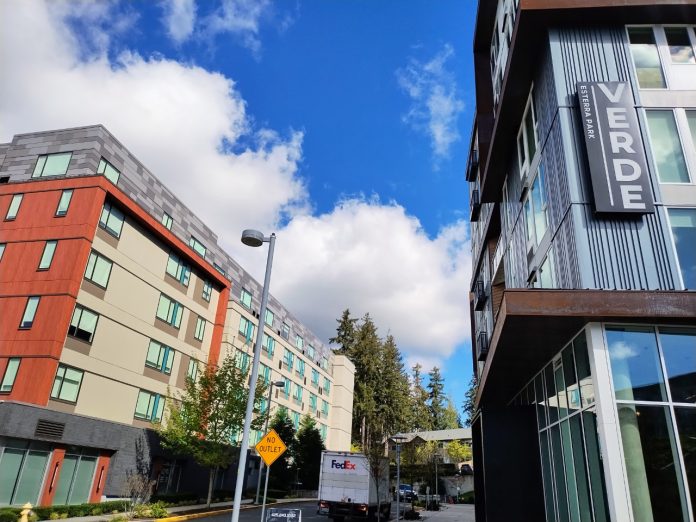 Redmond TOD Two apartment buildings seen on a beautiful day, with one having a label of "Verve", in Redmond's Overlake neighborhood.