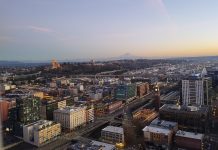 Seattle Planning Commission Pushes for Bolder Housing Growth Strategy A view from the Smith Tower at dusk looking toward Beacon Hill with Mount Rainier in the distance