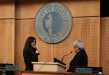 Alexis Mercedes Rinck Takes Office, Pledging Seattle Will Resist Trumpism The pair stand before the Seattle city seal at Seattle City Council chambers.