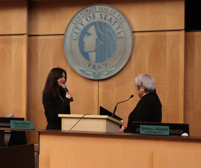 Alexis Mercedes Rinck gets sworn in The pair stand before the Seattle city seal at Seattle City Council chambers.
