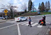 I-90 Ramps Will See Safety Upgrades Ahead of Judkins Park Station Opening Two people crossing the ramp with one car already having disregarded them. One person is in a wheelchair.