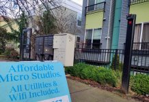 Lawmakers Reach Rent Stabilization Compromise A sign in front of an apartment building advertising "Affordable Micro Studios" with utilities and wifi included