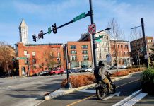 Seattle Releases Road Map for Transportation Levy Spending in 2025 and Beyond Someone on a bike using the new waterfront bike lane with a brightly lit city in the background