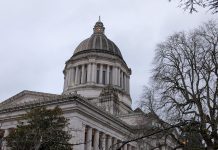 State Lawmakers Move to Regulate License Plate Readers, Fearing ICE Misuse The Olympia capital building with some trees in the foreground.