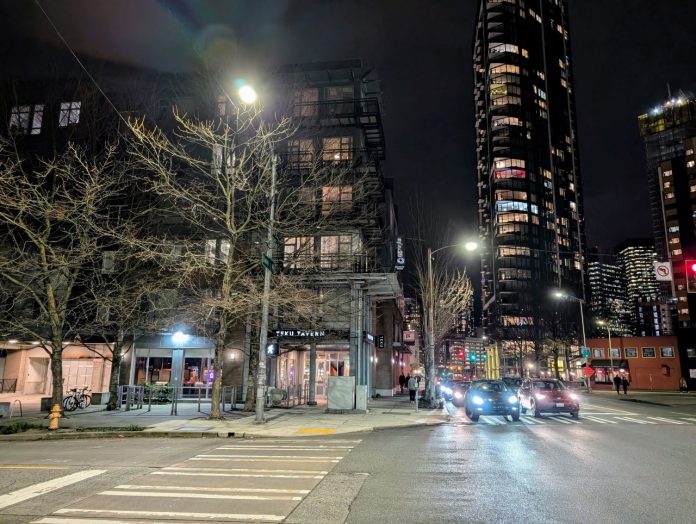 TeKu Tavern and Denny Way skyline by Doug Trumm Teku Tavern and the view east up Denny Way with skyscrapers shining in the night in the background.