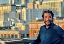 OPCD Further Trims Corridor Upzones in Newly Unveiled Seattle Zoning Maps Rico is a Black man with braids and a button up shirt posing in front of the Seattle skyline