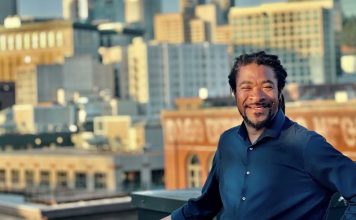 OPCD Further Trims Corridor Upzones in Newly Unveiled Seattle Zoning Maps Rico is a Black man with braids and a button up shirt posing in front of the Seattle skyline