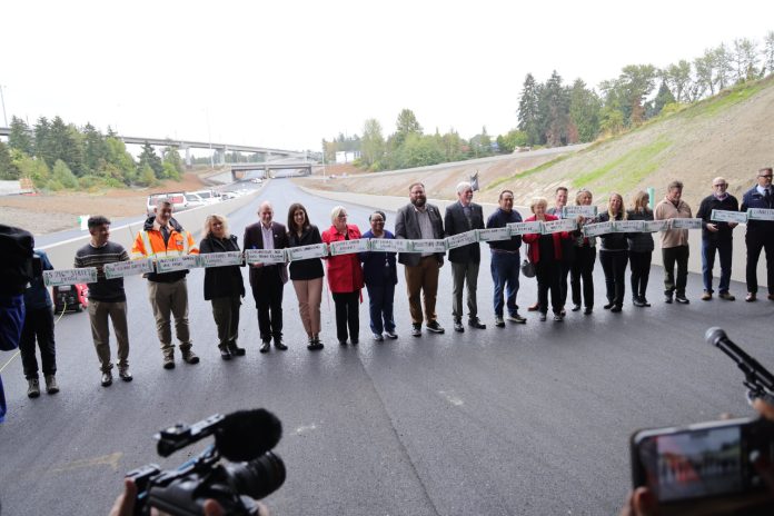 54040720450_a7373cf66e_k A long line of legislators and other leaders standing on a new segment of SR 509 before a ribbon is cut