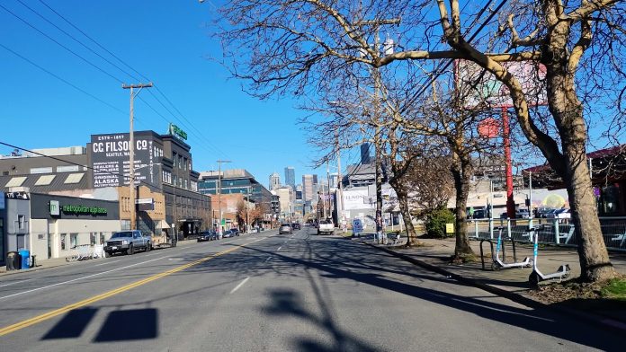 Seattle's Stadium District The view of wide, but empty First Avenue looking north toward Downtown, with low-slung industrial, strip mall, and parking lots around it.
