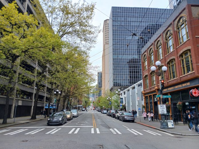 First Avenue Seattle A view north up First Avenue shows a hodge of Pioneer Square historic brick buidlings, tall glass scrapers and a large parking garage.