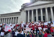 Op-Ed: Washington Landlords Spending Big, Playing Dirty to Block Rent Stabilization Hundreds of advocates hold signs on the steps of the Capitol Building.