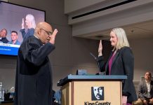 King County Council Appoints Shannon Braddock Acting Executive in Constantine’s Wake A judge in black robes swears in Braddock who raises her right hand and stands next a lectern with King County's MLK logo. She is a middle-aged blond woman.
