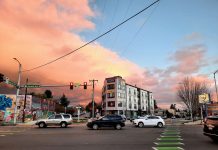 Harrell Chops Off Dozens of City Blocks from Planned Growth Centers A five-story apartment building along Aurora Avenue with the sunset in the background.