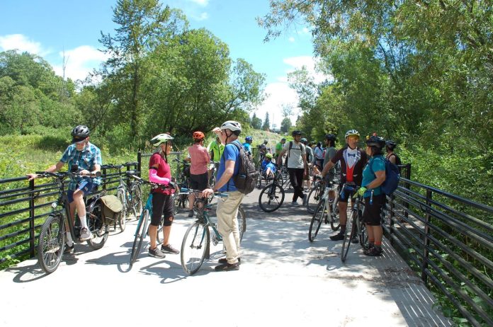lake to sound trail cascade bike club a_engelson A group of over dozen people with their bikes on a wetland boardwalk segment of the trail.