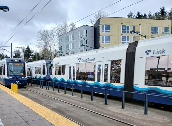 Two Link trains at an at-grade station in the Rainier Valley