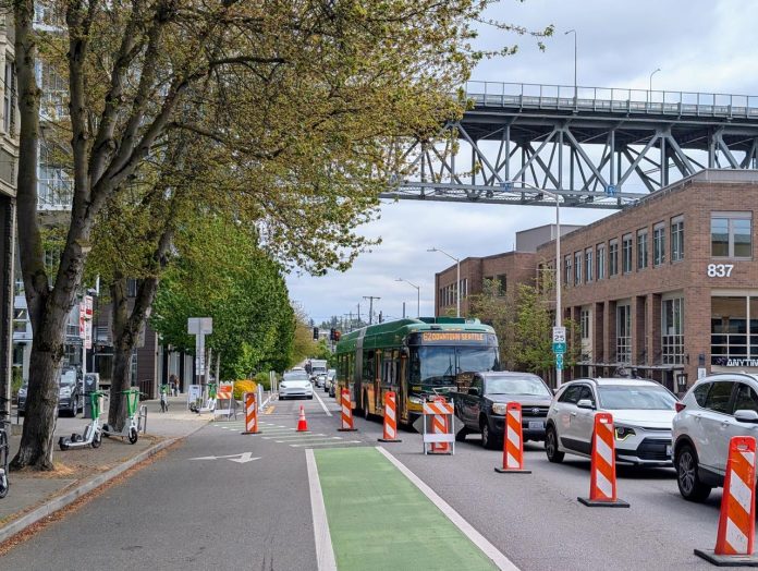 The view east up N 34th Street with the steel-spanned Aurora Avenue bridge in the distance.