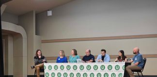 Join Us for Our January Socials and North Sound Election Debrief The six panelists sit at a table with the Urbanist U logo on it and Ryna Packer is off to the side moderating.