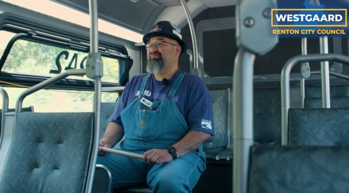 Michael Westgaard on Bus Westgaard wears denim overalls and has a goatee and glasses