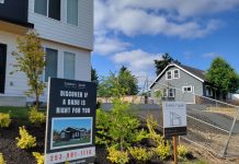 Fire Marshals Target Backyard Cottages with Proposal for Wider Pathway Requirements A sign says "Discover if an ADU is right for you" in front of a home with a backyard cottage.