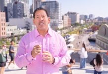 Harrell Budget Doubles Down on Police Spending Harrell weather a pink button up shirt with pedestrians on the Overlook Walk in the background.