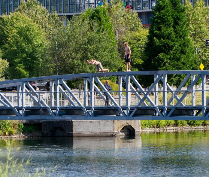 24_0812 Kenmore Air Bridge Divers_small two guys jumping off the top of the ped bridge