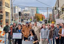 Rinck Launches ‘Better Bus Lanes’ Campaign with Transit Advocates More than two dozen advocates stand behind Rinck at the bus stop at 12th Avenue and Union Street, with Madison Street in the background.