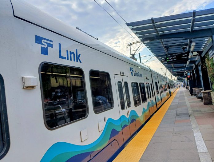 A Sound Transit light rail car passes through a station in the Rainier Valley