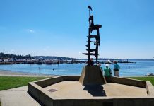 Kirkland Voters Maintain the City’s Course, Rejecting Anti-Growth Push A tower-like metal sculpture crowns Kirkland's Marina Park, with a few pedestrians walking on the path along its edge. The marina and Moss Bay is in the distance.