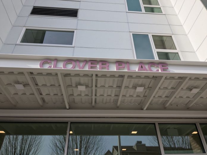 DESC Clover Place sign - Sundberg 20260204 The metal awning includes the building name in red letters. The building has a white facade.