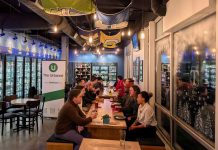 Join Us for February Urbanist Socials and Waterways Presentation March 3rd About 20 urbanists sit around a long table in the tavern.